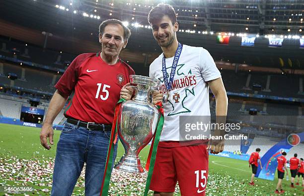 Andre Gomes of Portugal poses with the trophy following the UEFA Euro 2016 final match between Portugal and France at Stade de France on July 10,...