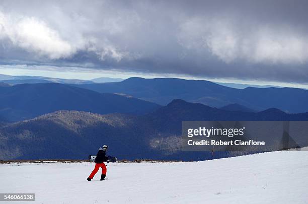 Snowboarder walks up the slopes on July 11, 2016 in Mount Buller, Australia.