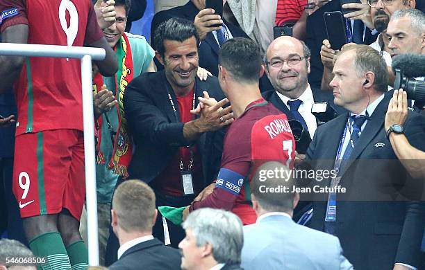 Luis Figo greets Cristiano Ronaldo of Portugal during the trophy ceremony of the UEFA Euro 2016 final between Portugal and France at Stade de France...