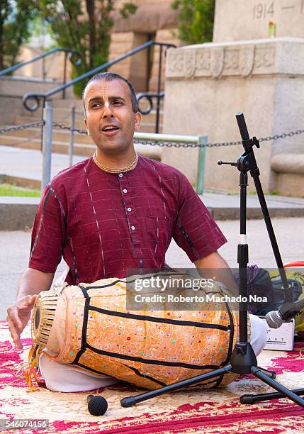 Canada Day people: Hare Krishna members playing mantras in front of Old City Hall Hare Krishna is a religion that favors celibacy, vegetarism and...