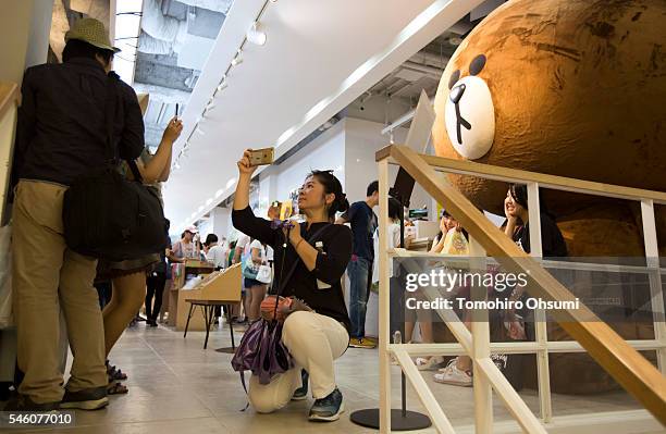 Customer takes a photograph using smartphone inside Line Corp.'s LINE Friends Harajuku store on July 11, 2016 in Tokyo, Japan. Japanese messaging app...