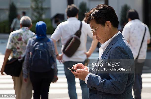 Man uses a smartphone on July 11, 2016 in Tokyo, Japan. Japanese messaging app provider LINE Corp., owned by South Korean portal Naver Corp.,...