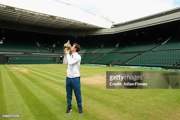 Andy Murray of Great Britain revisits centre court as he kisses the trophy at Wimbledon on July 11, 2016 in London, England.