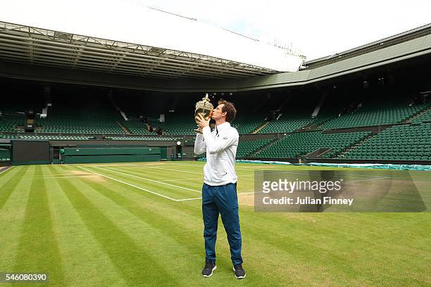 Andy Murray of Great Britain revisits centre court as he kisses the trophy at Wimbledon on July 11, 2016 in London, England.