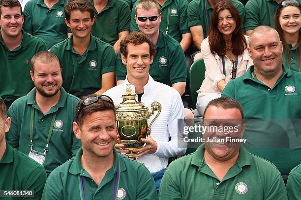 Andy Murray of Great Britain revisits centre court and meets members of the ground staff at Wimbledon on July 11, 2016 in London, England.