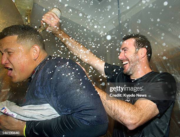 United States - Detroit Tigers pitcher Justin Verlander pours champagne on infielder Miguel Cabrera to celebrate their team's victory in Game 5 of...