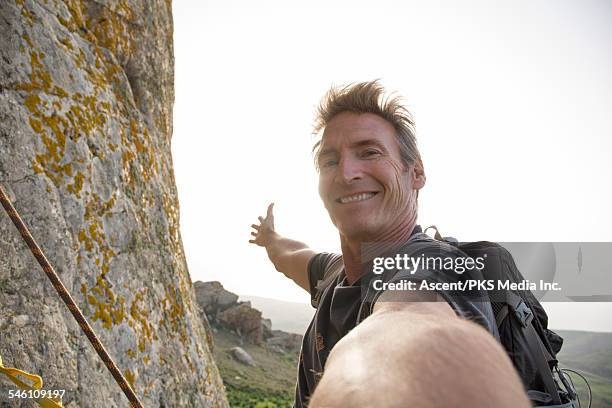 climber takes selfie form mountain wall, above sea - extreme angle stock pictures, royalty-free photos & images