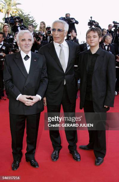 French singer Charles Aznavour, actor/singer Gerard Darmon and actor Damien Jouillerot pose as they arrive for the screening of French directors...