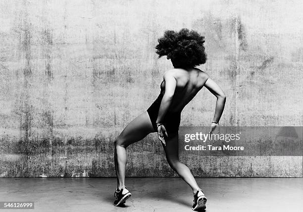 female dancer krumping in urban studio setting - modern dancing stock pictures, royalty-free photos & images