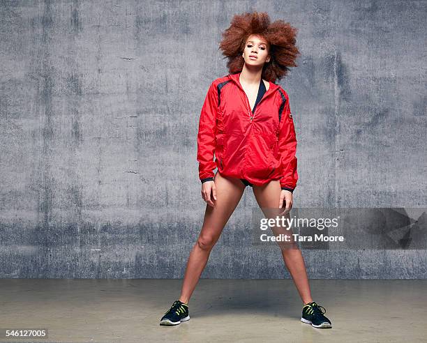 portrait of sportswoman in urban studio - red jacket stock pictures, royalty-free photos & images