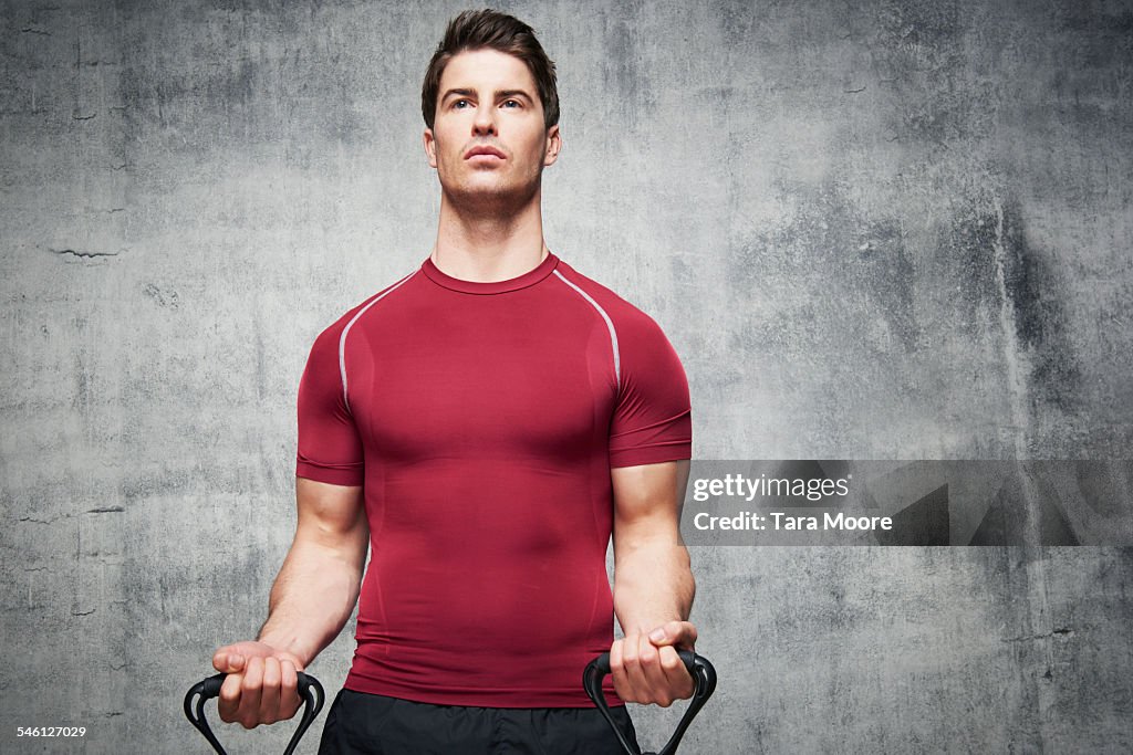 Man exercising with stretch band in urban studio