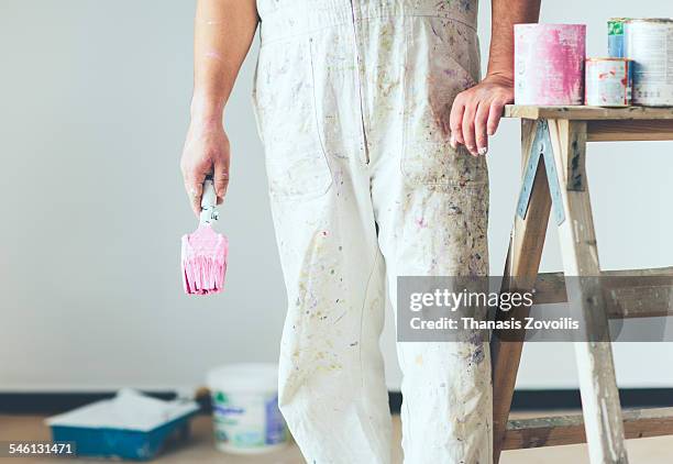 painter working in refurbishment - pintor fotografías e imágenes de stock