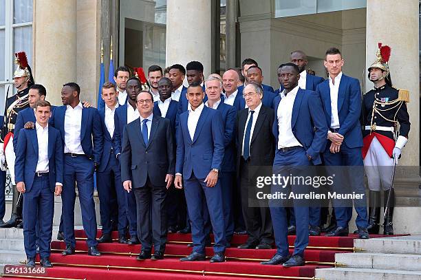 French President Francois Hollande poses with the soccer France national team as they arrive at Elysee Palace for a lunch in their honor on July 11,...