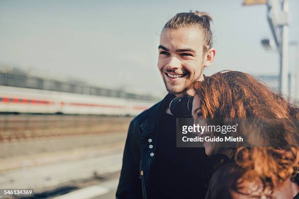 happy young couple. - railroad station stock pictures, royalty-free photos & images