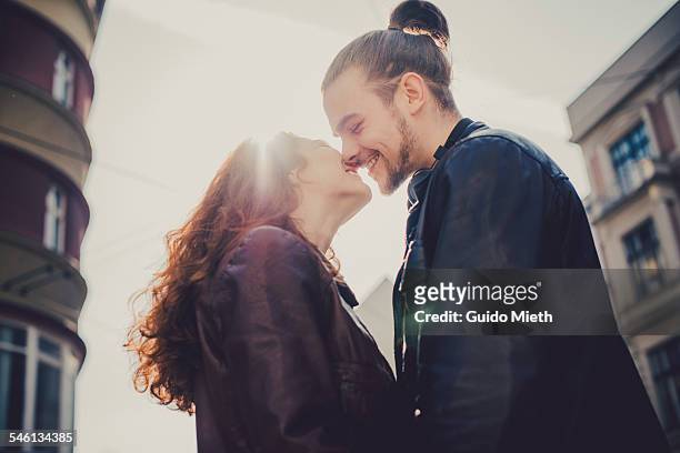 smiling couple before kissing. - kiss stock-fotos und bilder