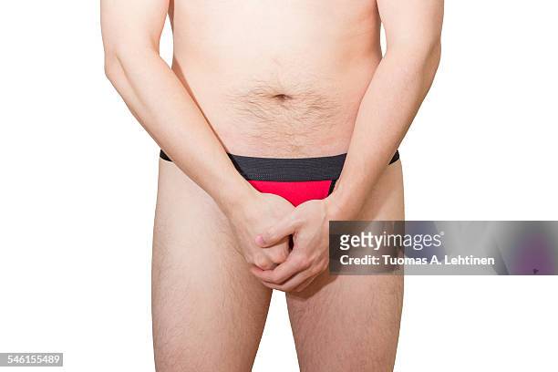 man underwear holding/hiding/protecting his penis - genitals stock-fotos und bilder