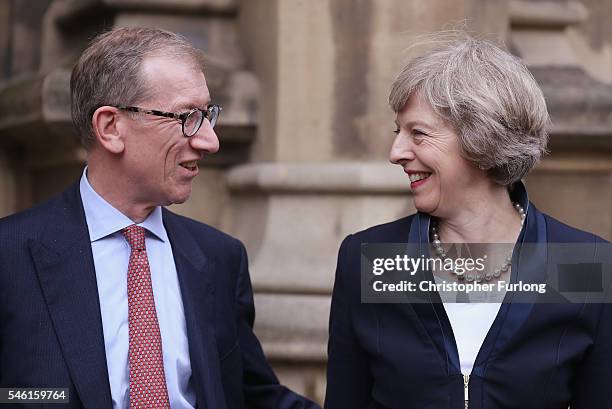 British Home Secretary Theresa May stands with her husband Philip John May before she makes a statement surrounded by members of the Tory party after...