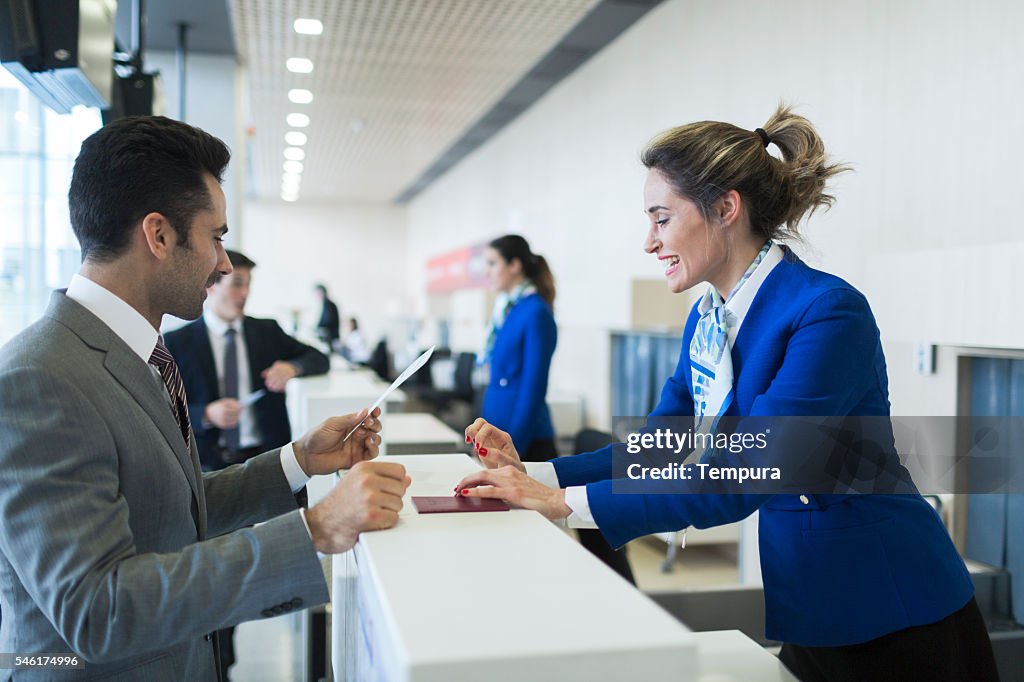 Business man in check-in counter with boarding pass.