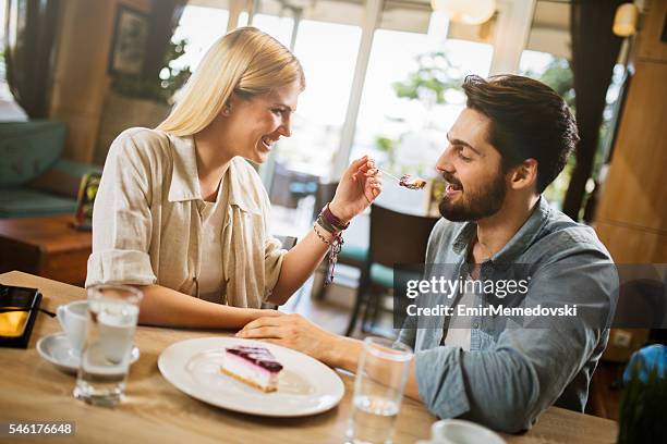 lovely couple enjoying dessert in cafe . - man eating pie stock pictures, royalty-free photos & images