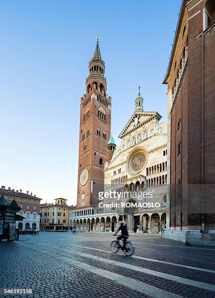 cremona cathedral  at dusk with biker, lombardy italy - cremona stock pictures, royalty-free photos & images