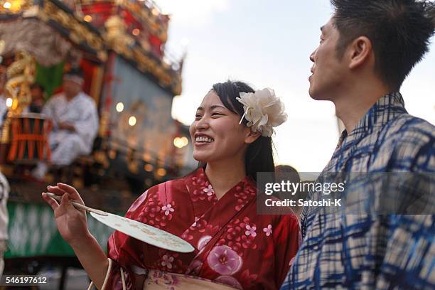 young couple enjoy watching parade float at festival - festival float stock pictures, royalty-free photos & images