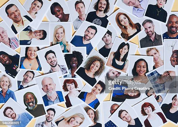 scattering of printed portraits - multiracial group stock-fotos und bilder