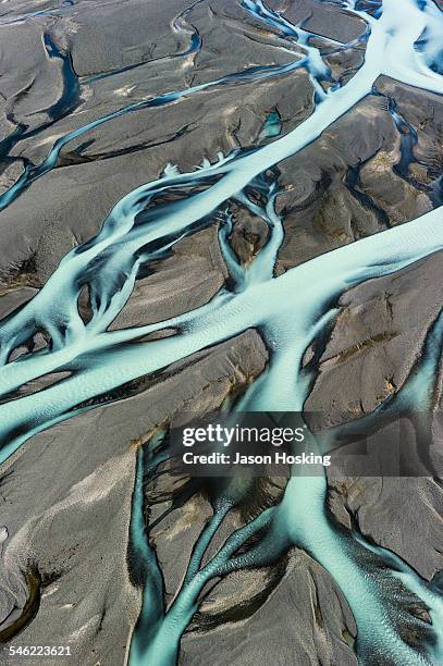 aerial view of braided river from melting glacier - glacier stock-fotos und bilder