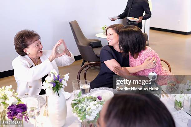 Congresswoman Nita Lowey takes a picture of Glamour editor in chief Cindi Leive and actress Uzo Aduba during a luncheon hosted by Glamour and...