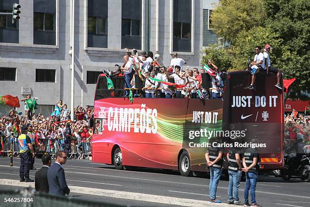 Portuguese players waving to Portuguese supporters during the Portugal Euro 2016 Victory Parade at Lisbon on July 11, 2016 in Lisbon, Portugal.