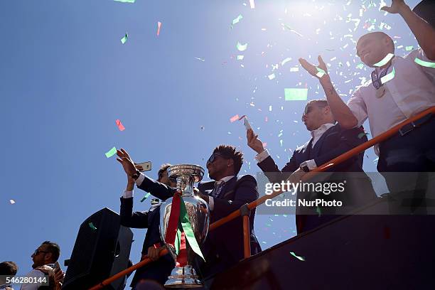 Portuguese midfielder Eliseu holds the European Cup and show it to the Portuguese supportes during the Portugal Euro 2016 Victory Parade at Lisbon on...