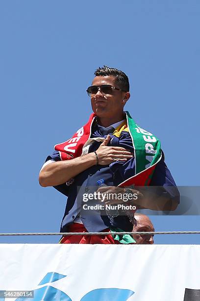 Portuguese forward Cristiano Ronaldo speaks to the Portuguese supportes during the Portugal Euro 2016 Victory Parade at Lisbon on July 11, 2016 in...