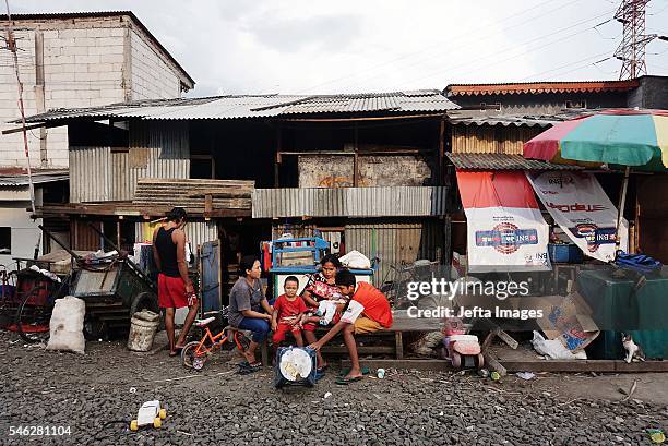 Indonesian residents stand near the railway tracks at the Slum area on July 09, 2016 in Jakarta, Indonesia. Indonesia is the most populous country in...