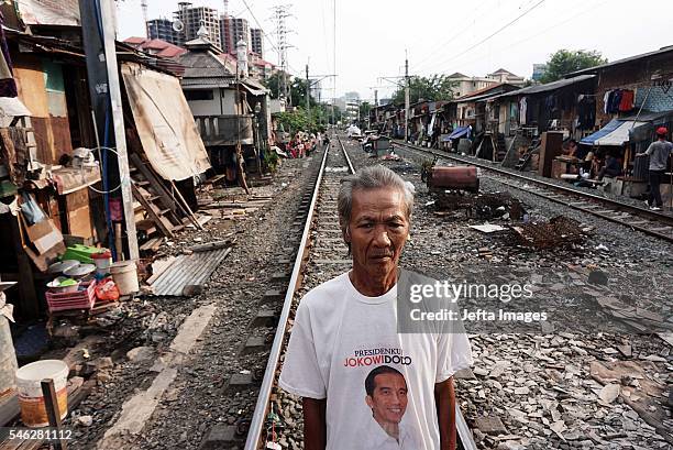 Indonesian residents stand near the railway tracks at the Slum area on July 09, 2016 in Jakarta, Indonesia. Indonesia is the most populous country in...
