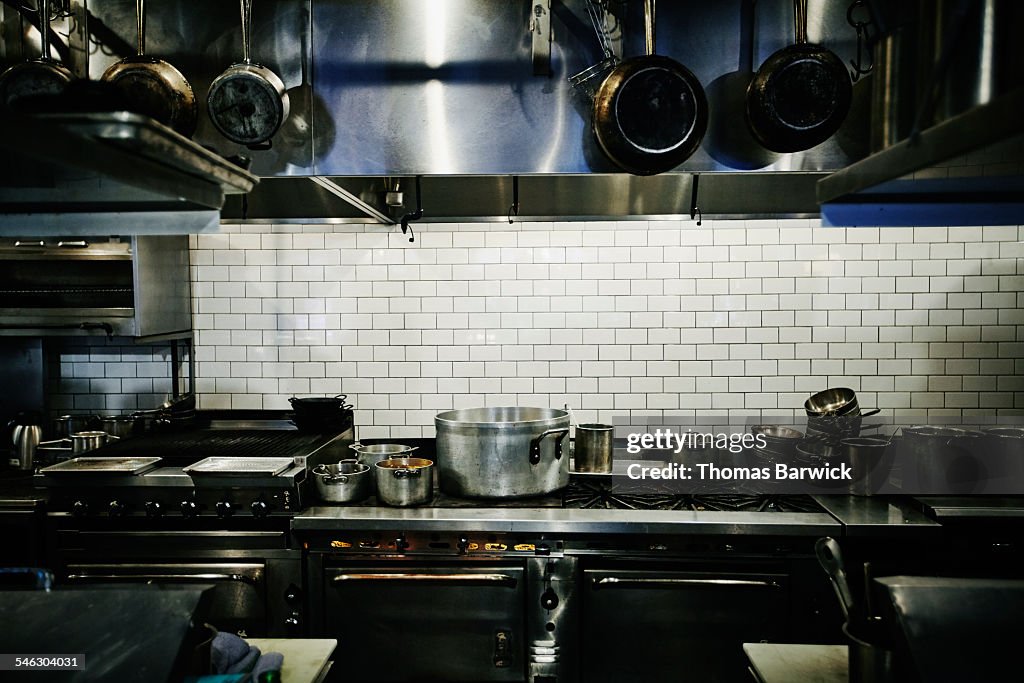 Pots simmering on range in restaurant kitchen