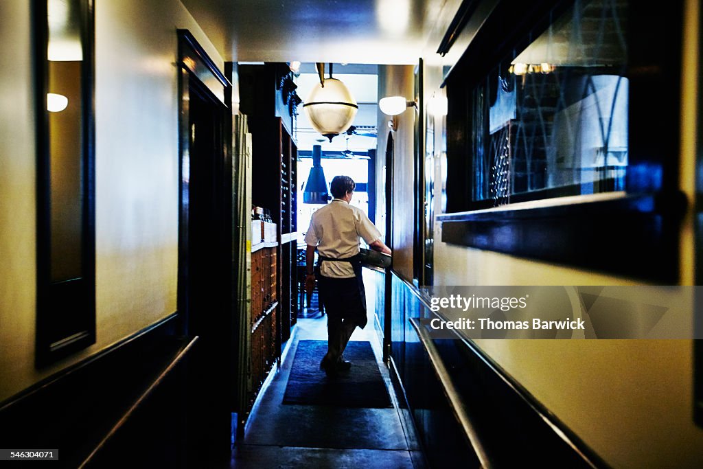 Chef walking down restaurant hallway