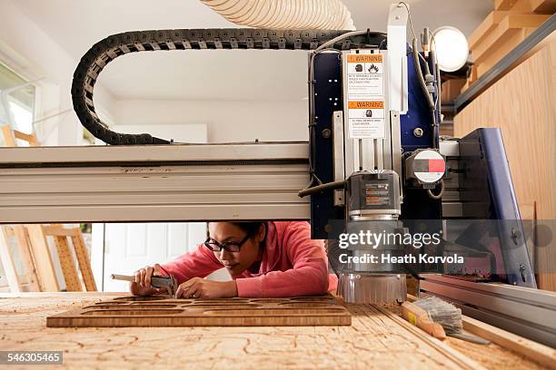 female maker doing hand work in garage workshop. - anesthetic machine stock-fotos und bilder