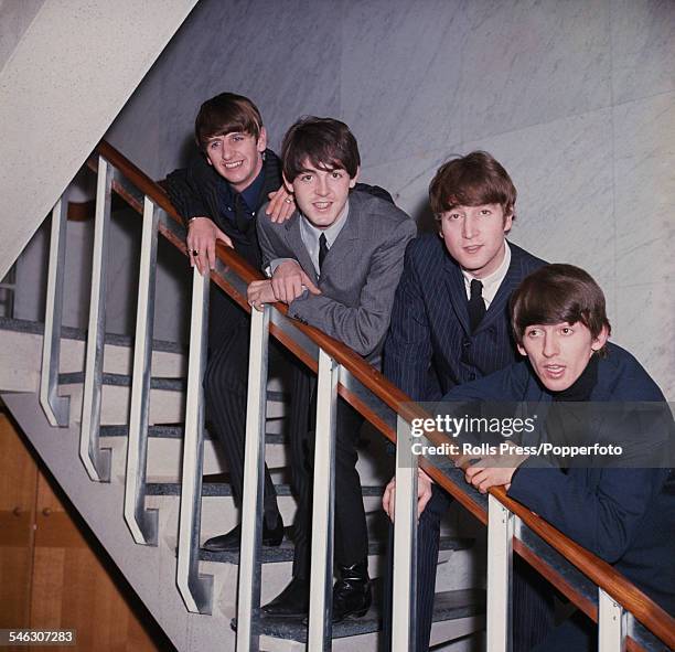 English pop group The Beatles posed on a staircase in 1964. From left to right: Ringo Starr, Paul McCartney, John Lennon and George Harrison.