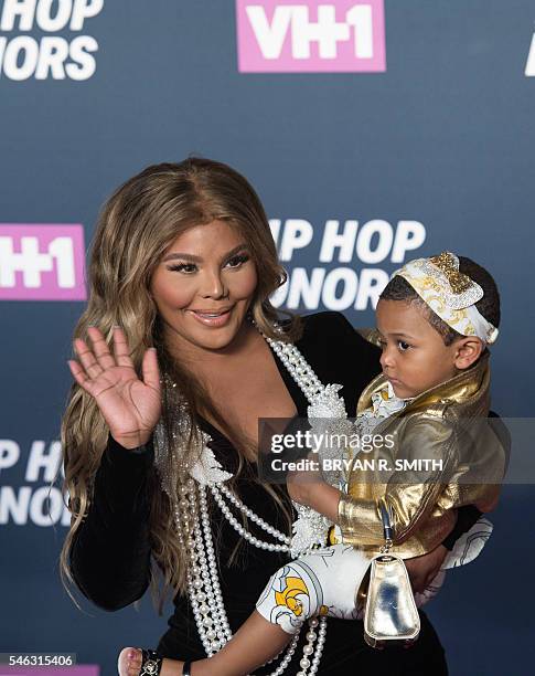 Lil Kim holds her daughter Royal Reign as she arrives for "VH1's Hip Hop Honors: All Hail The Queens" on July 11, 2016 at Lincoln Center in New York....