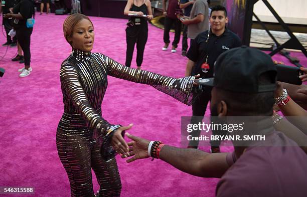 Eve greets fans as she arrives for "VH1's Hip Hop Honors: All Hail The Queens" on July 11, 2016 at Lincoln Center in New York. / AFP / Bryan R. Smith