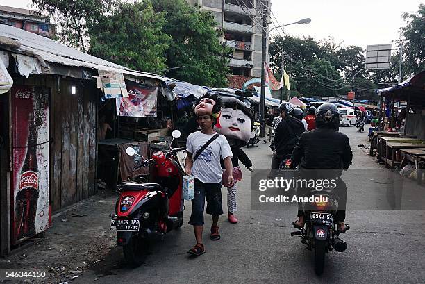 Street entertainers dressed as dolls are seen at the Slum area in Jakarta, Indonesia, on July 11, 2016. Indonesia is the most populous country in...