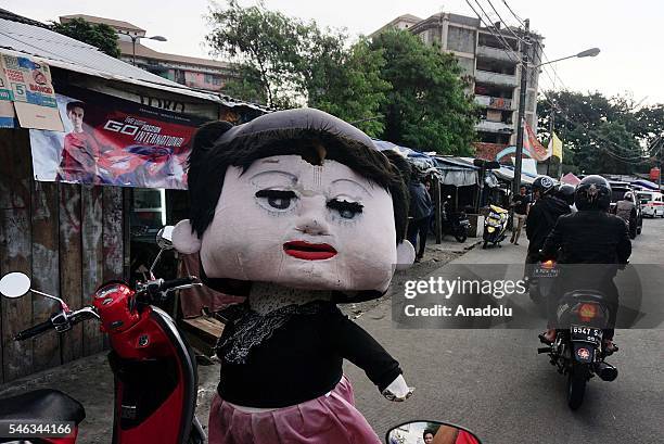 Street entertainer dressed as doll is seen at the Slum area in Jakarta, Indonesia, on July 11, 2016. Indonesia is the most populous country in...