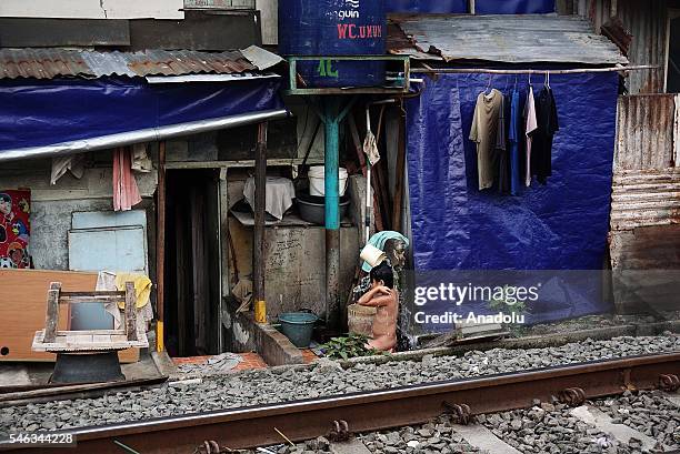 An Indonesian kid takes a bath near the railway tracks at the slum area in Jakarta, Indonesia, on July 11, 2016. Indonesia is the most populous...