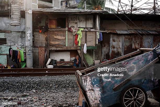 An Indonesian man sits on the railway tracks at the slum area in Jakarta, Indonesia, on July 11, 2016. Indonesia is the most populous country in...
