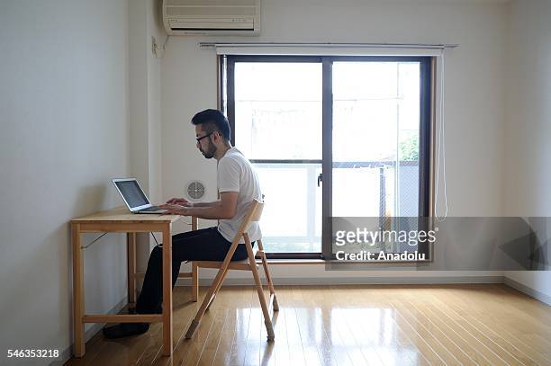 Minimalist Fumio Sasaki is seen in his apartment in Tokyo, Japan, on June 24, 2016. Fumio Sasaki Editor, decided to live less cluttered with useless...