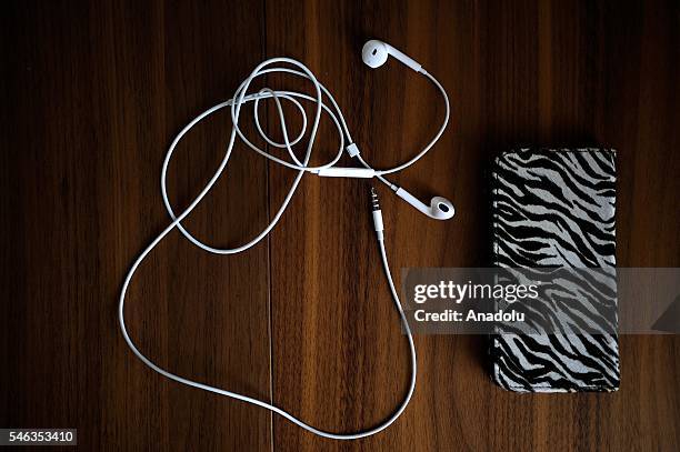 Smartphone and earphones are seen on the table of minimalist Saeko Kubishiki in Fujisawa, Kanagawa Prefecture in the southern of Tokyo, Japan, on...