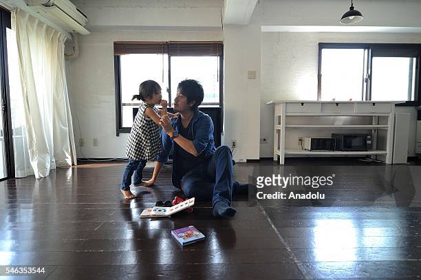 Minimalist Naoki Numahata talks to his three-years-old daughter Ei in the center of the living at their home in Tokyo, Japan, on July 02, 2016. Naoki...