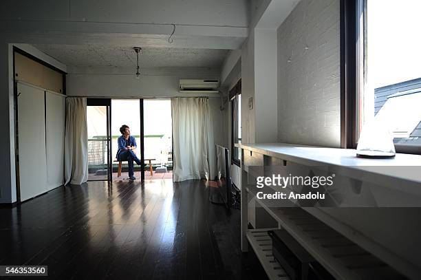 Minimalist Naoki Numahata is seen sitting in his balcony at his apartment in Tokyo, Japan, on July 02, 2016. Naoki Numahata a freelance writer who...