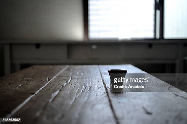 Cup is seen on a table at the Minimalist Naoki Numahatas home in Tokyo, Japan, on July 02, 2016. Naoki Numahata a freelance writer who lives with his...