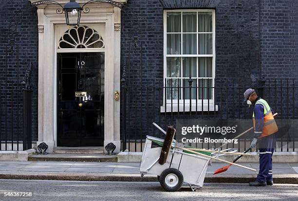 Street cleaner passes the door of 10 Downing Street in London, U.K., on Tuesday, July 12, 2016. U.K. Home secretary Theresa May now has just two days...