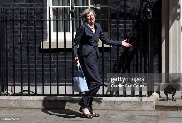 Prime Minister-in-waiting, Theresa May, reacts to photographers after walking to the wrong car after attending a Cabinet meeting at Downing Street on...